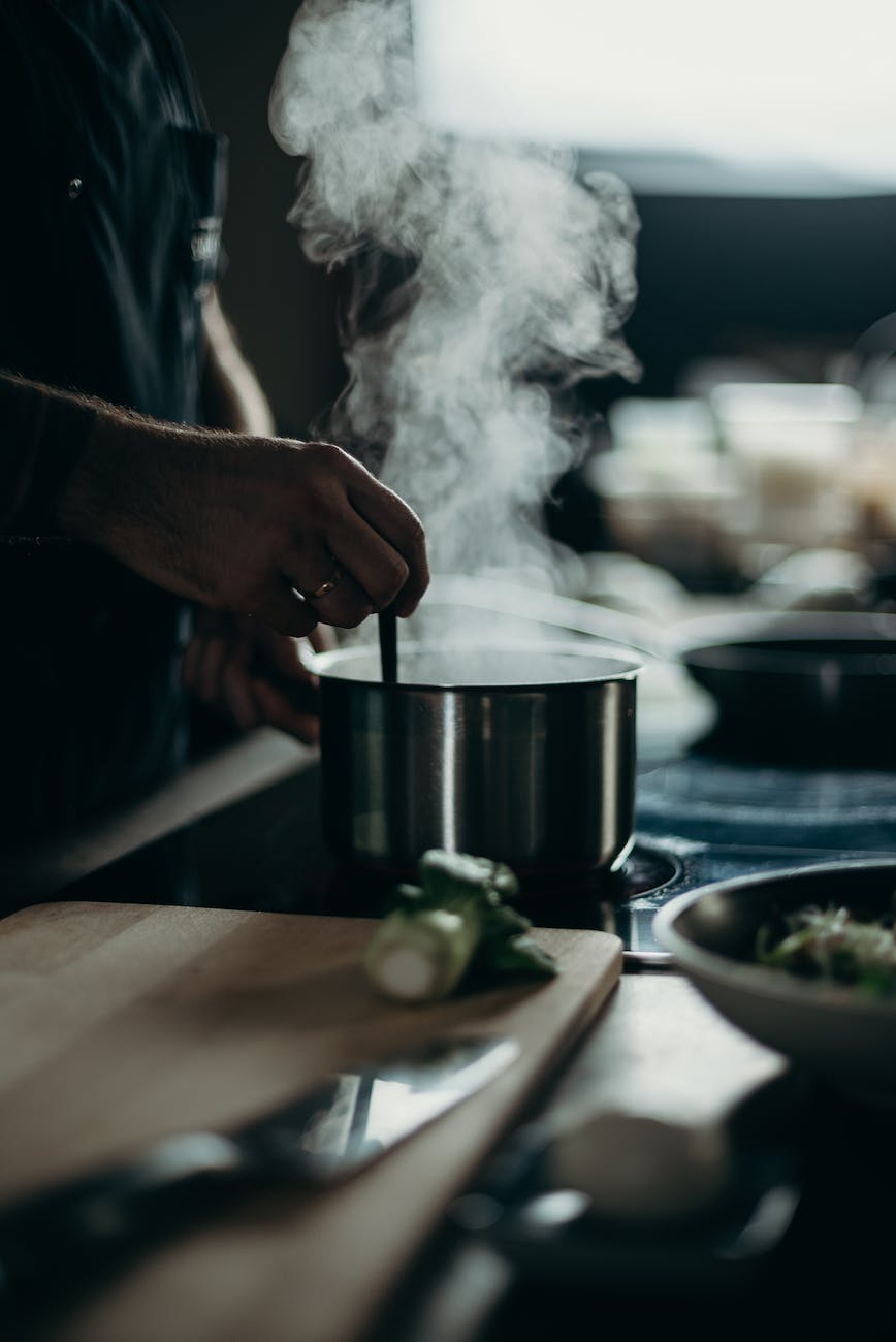 person cooking in pot